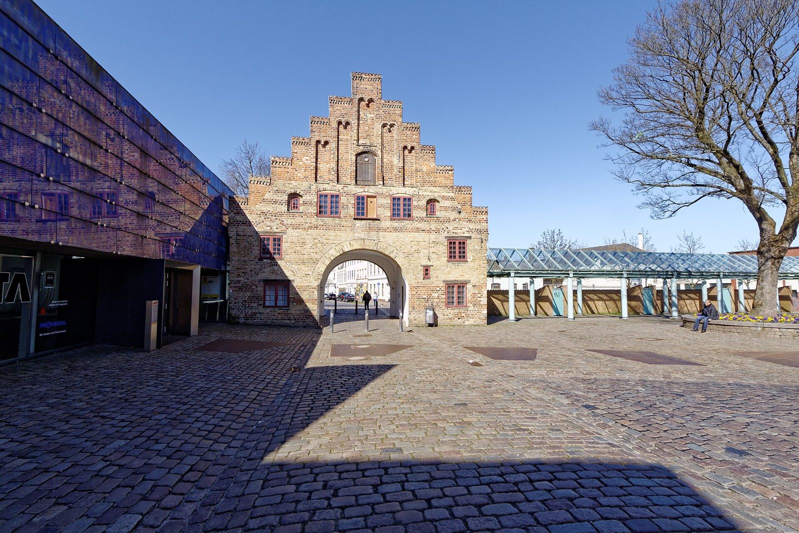 Das historische Nordertor in Flensburg mit Treppengiebel aus rotem Backstein unter blauem Himmel