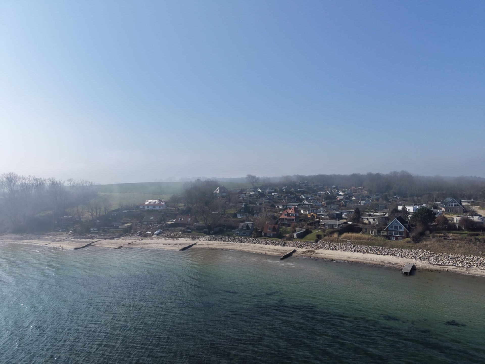 Luxury beachfront holiday home with private jetty at sunset on the Baltic Sea